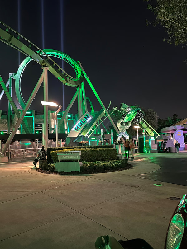 Picture of Hulk signage out front of the ride at night