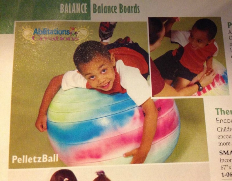 Picture of small boy on a balance ball in a catalog.