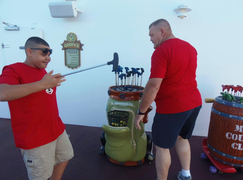 Picture of father and son on Disney Dream playing Goofy Golf
