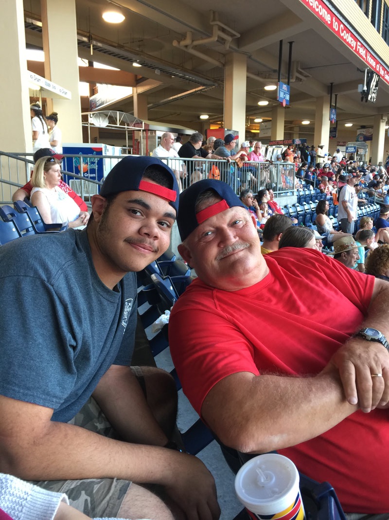 My Son and Husband attending a Gwinnett Braves game a few years ago by JMorrisTravel