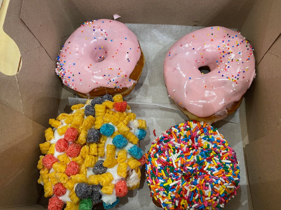 Picture of box of 4 doughnuts from Voodoo Doughnuts in City Walk.